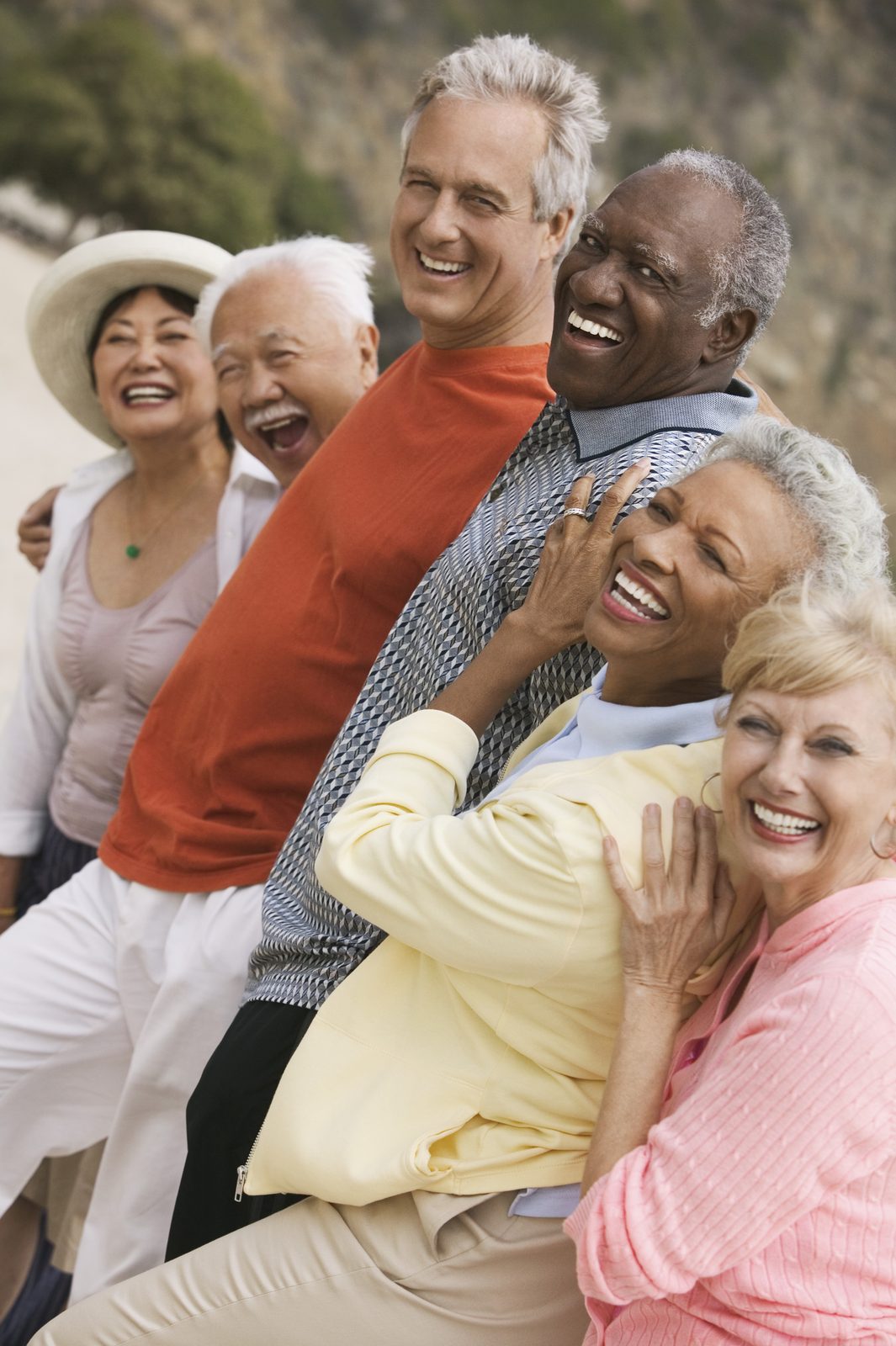 A group of happy retirees laughing together outdoors
