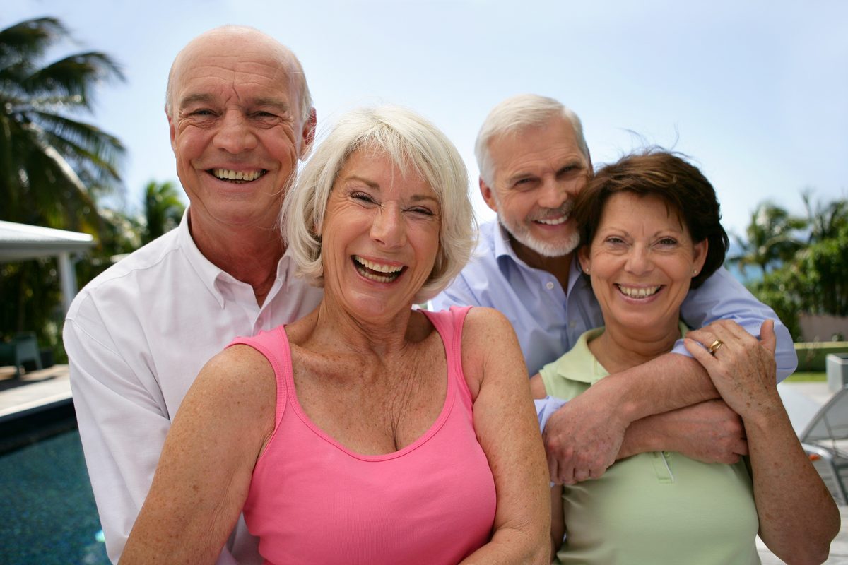 Smiling retirees enjoying time together by a pool